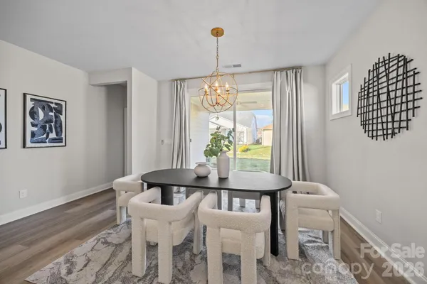 a bedroom with furniture and a large window