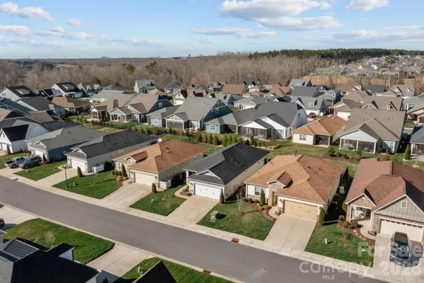 a aerial view of multiple houses with a big yard