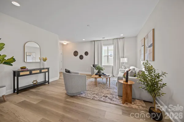 a living room with furniture and potted plant