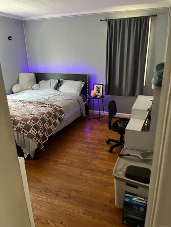 a bedroom with a bed and a chair
