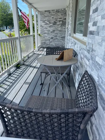 a view of balcony with wooden floor