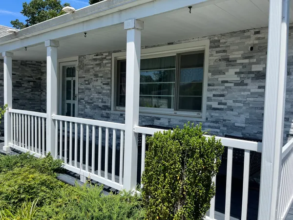 a view of a house with a window and a yard