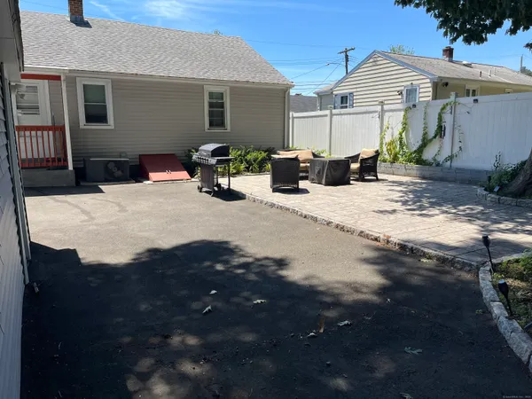 a view of a terrace with chairs and potted plants