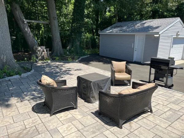 a view of a patio with table and chairs with wooden floor and fence