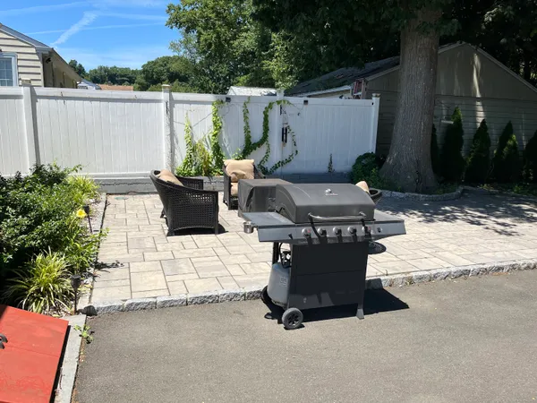 a view of a chairs and table in backyard