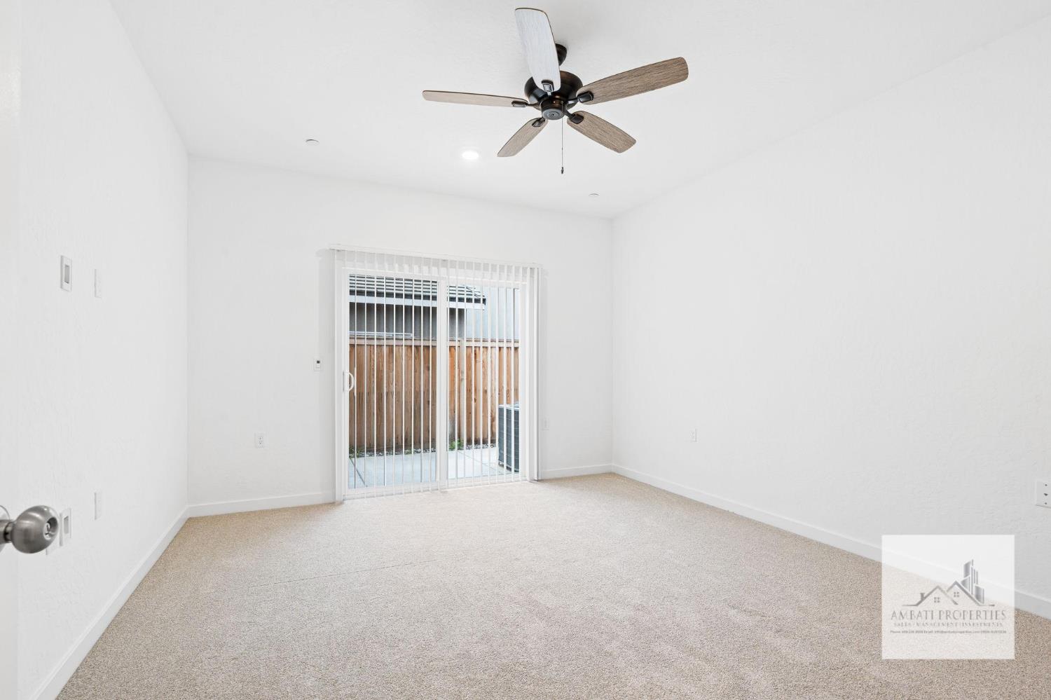 1017 Springtime Avenue Clovis, CA 93619 - Photo 12 of 13 an empty room with a ceiling fan and a window
