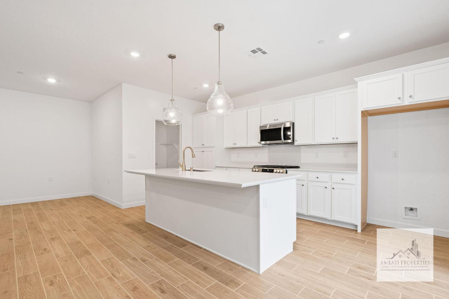 1017 Springtime Avenue Clovis, CA 93619 - Photo 5 of 13 a kitchen with stove top oven and refrigerator