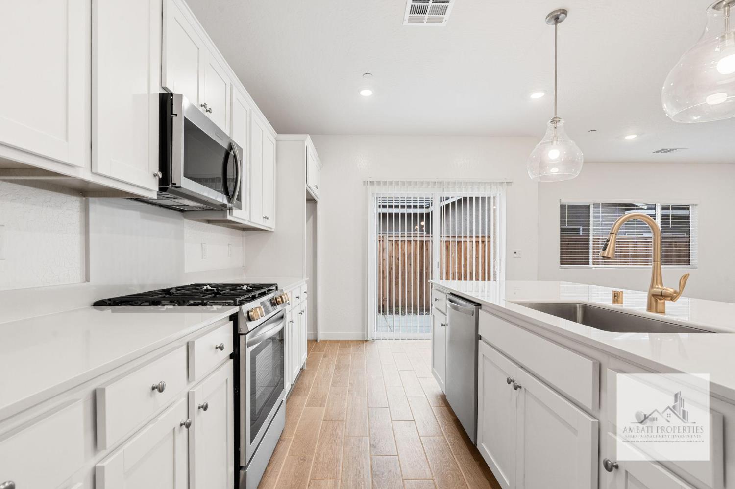 1017 Springtime Avenue Clovis, CA 93619 - Photo 6 of 13 a kitchen with stainless steel appliances granite countertop a sink and a stove