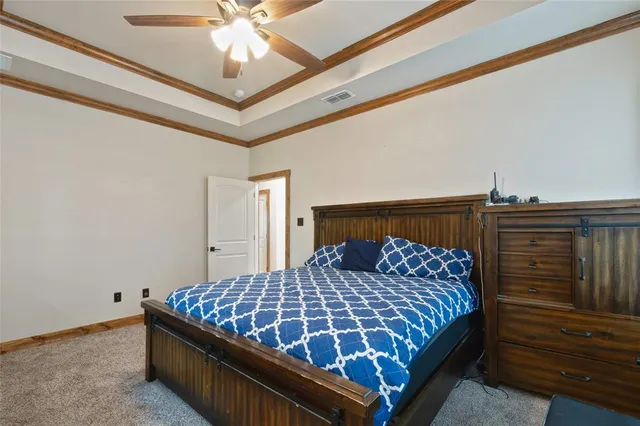 a bedroom with a bed and ceiling fan