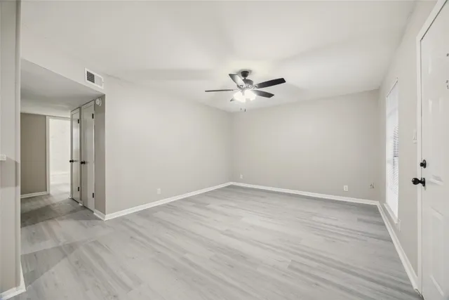 a view of an empty room with a fan