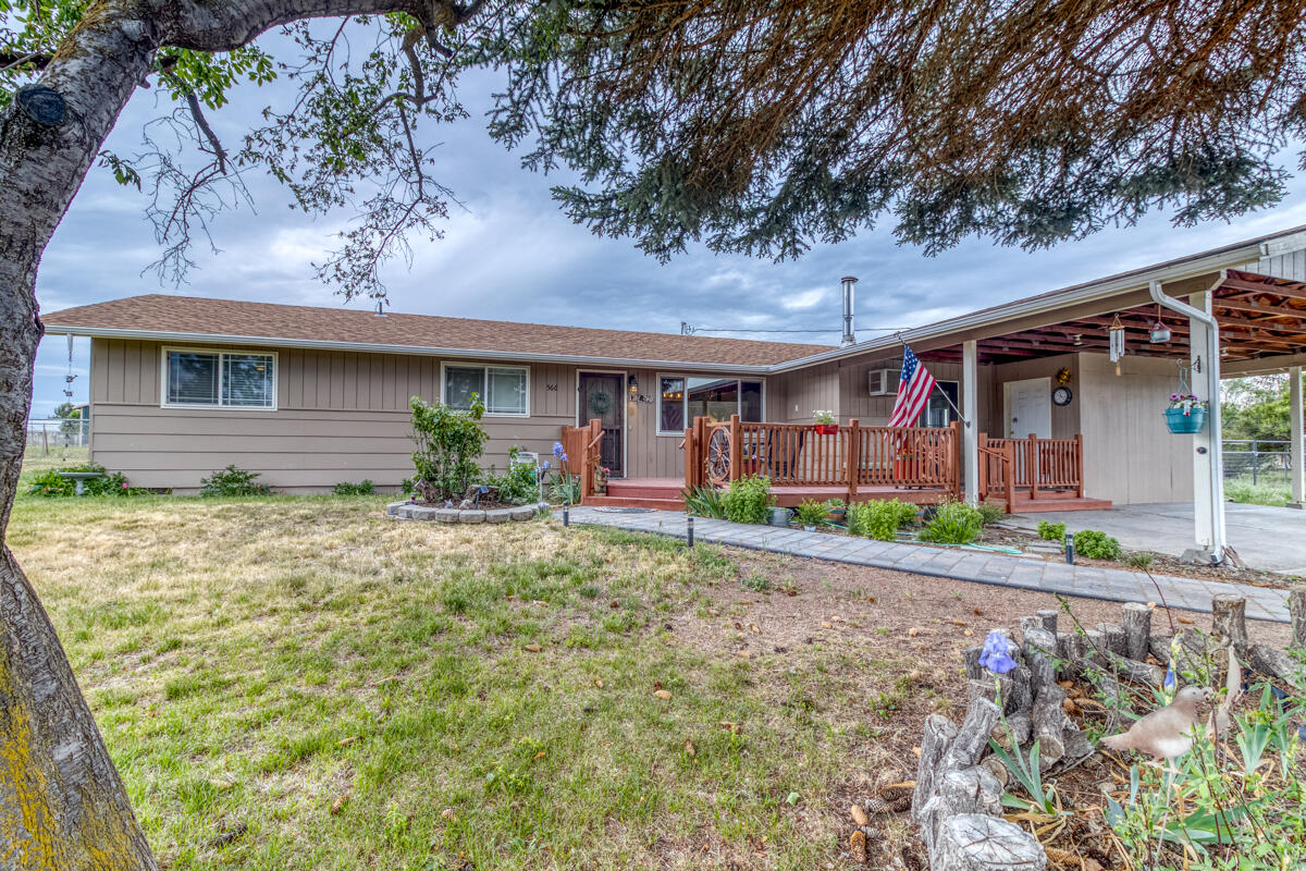 566 Northwest Mc Donald Road Prineville, OR 97754 - Photo 1 of 41 a front view of a house with garden