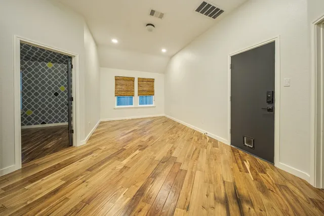 a bathroom with a tub sink shower and mirror