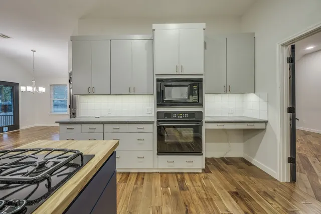a large kitchen with kitchen island a sink stainless steel appliances and cabinets