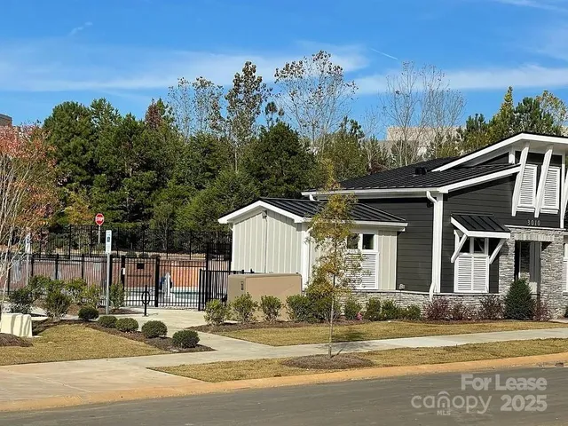 a front view of a house with garden and plants