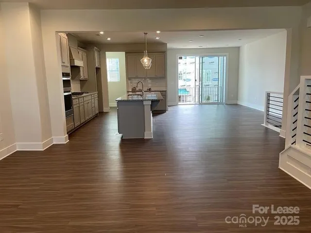 a view of kitchen and dining room with wooden floor