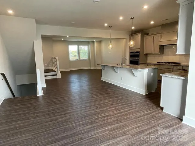 a view of kitchen with cabinets and wooden floor