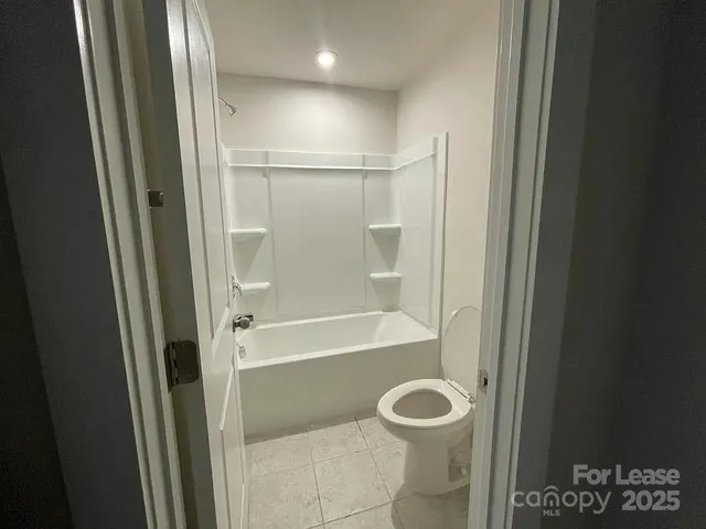 a bathroom with a granite countertop bathtub and a shower