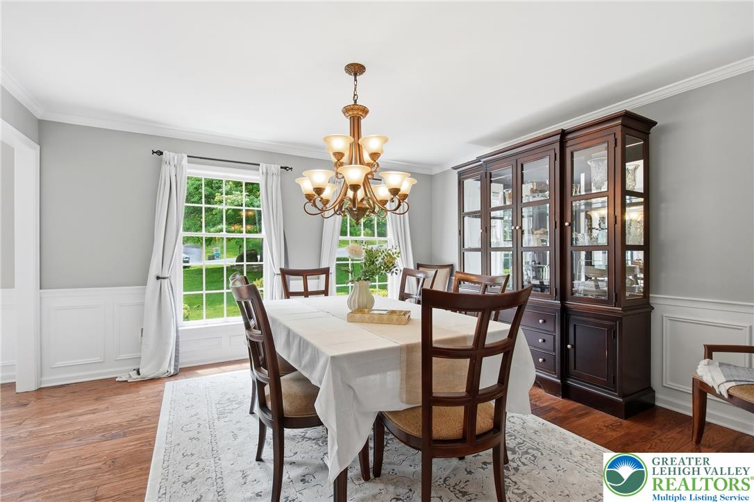 115 West Butternut Road Hellertown, PA 18055 - Photo 14 of 97 Formal dining space features elegant crown molding, wainscoting, and polished hardwood flooring.