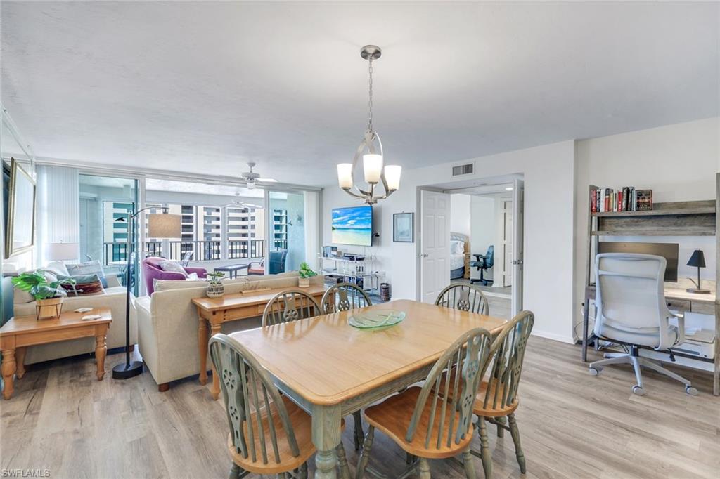 21 Bluebill Avenue, Unit B905 Naples, FL 34108 - Photo 12 of 35 a view of a dining room with furniture window and wooden floor