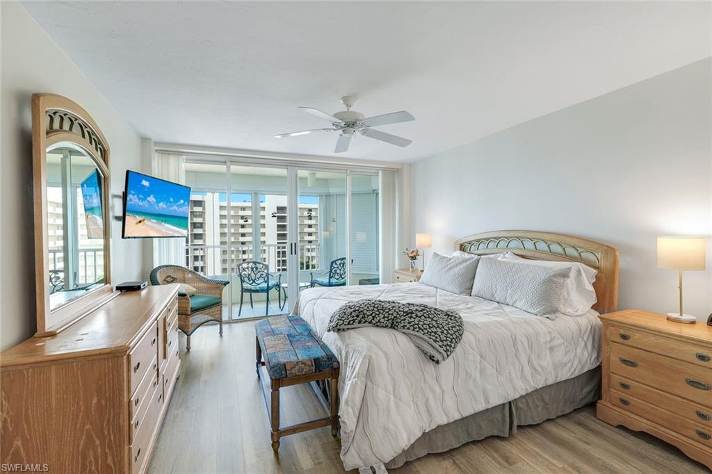 21 Bluebill Avenue, Unit B905 Naples, FL 34108 - Photo 15 of 35 a bedroom with a bed and a large window