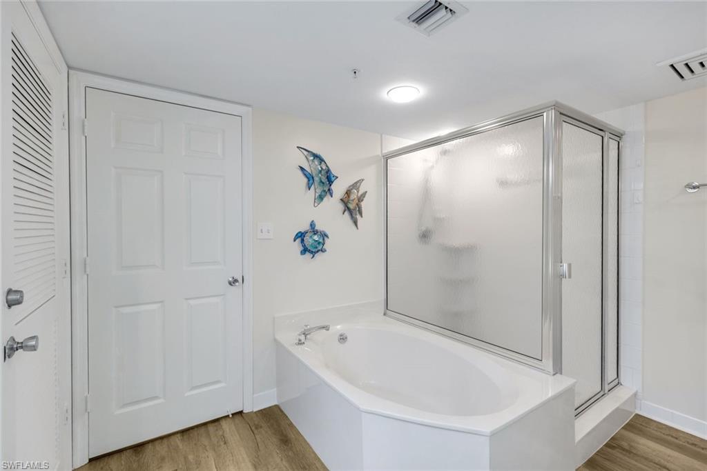 21 Bluebill Avenue, Unit B905 Naples, FL 34108 - Photo 20 of 35 a bathroom with a bathtub and a shower