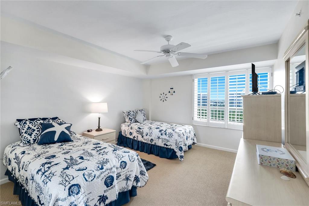 21 Bluebill Avenue, Unit B905 Naples, FL 34108 - Photo 21 of 35 a bedroom with two beds and a window