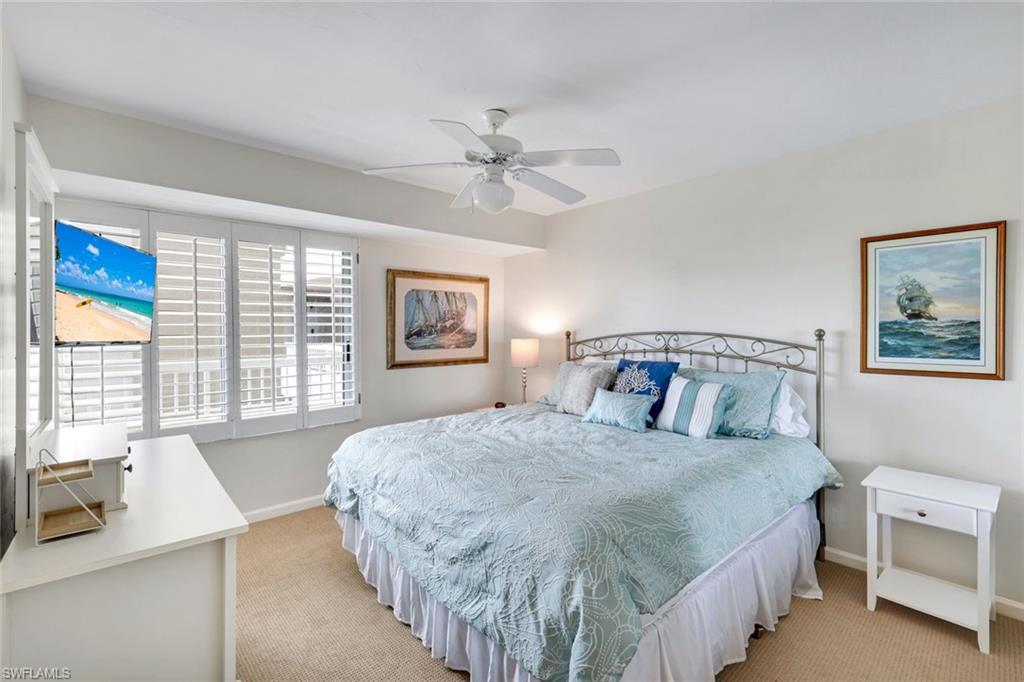 21 Bluebill Avenue, Unit B905 Naples, FL 34108 - Photo 23 of 35 a bedroom with a large bed and a window