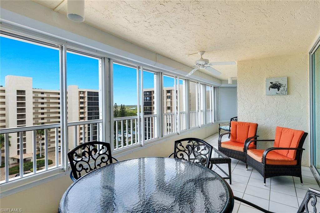 21 Bluebill Avenue, Unit B905 Naples, FL 34108 - Photo 25 of 35 a balcony with furniture and wooden floor