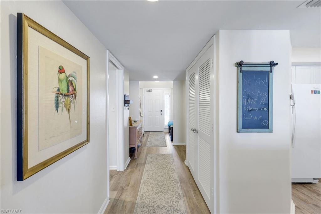 21 Bluebill Avenue, Unit B905 Naples, FL 34108 - Photo 3 of 35 a view of a hallway with wooden floor and closet