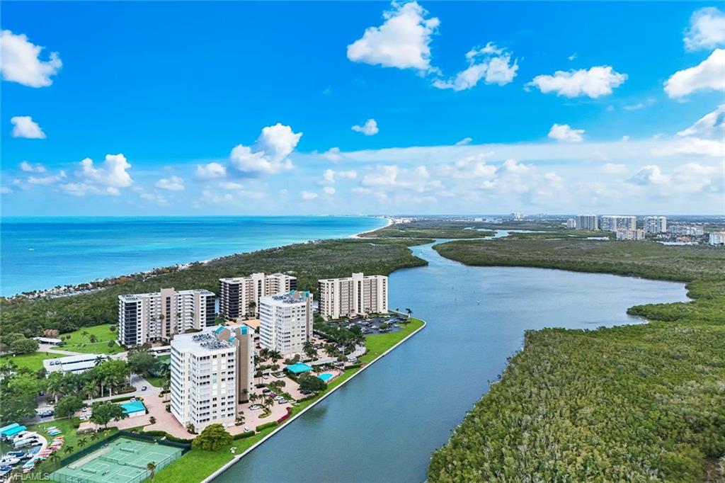 21 Bluebill Avenue, Unit B905 Naples, FL 34108 - Photo 35 of 35 a view of a lake with a building in the background