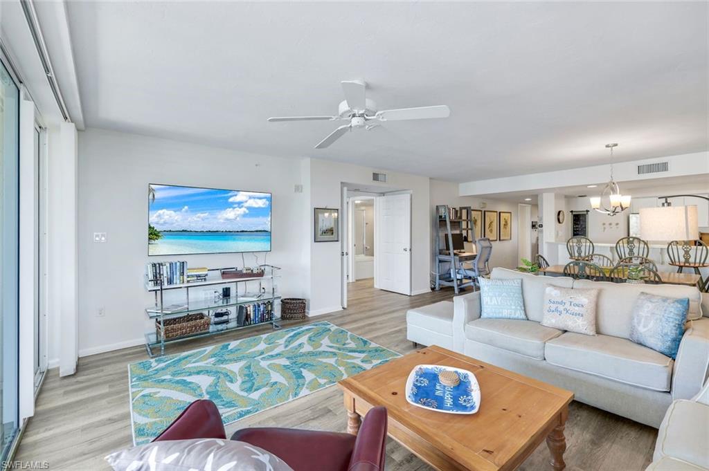 21 Bluebill Avenue, Unit B905 Naples, FL 34108 - Photo 6 of 35 a living room with furniture and a flat screen tv