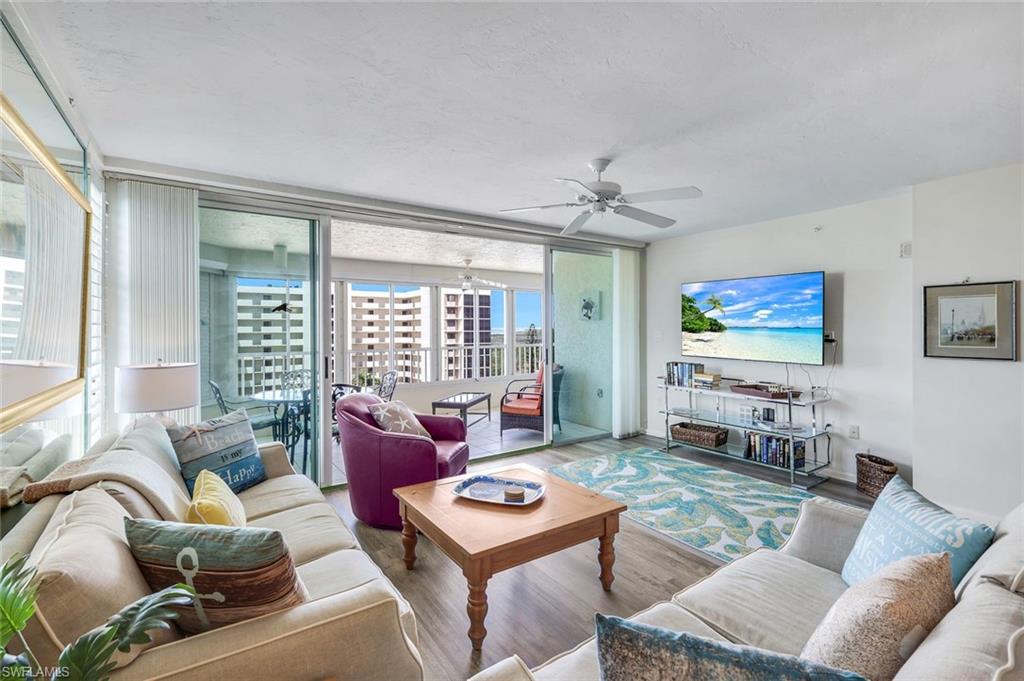 21 Bluebill Avenue, Unit B905 Naples, FL 34108 - Photo 7 of 35 a living room with furniture and a flat screen tv