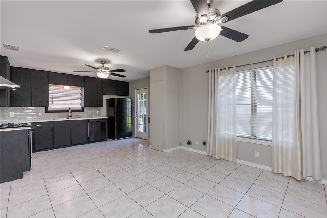 4122 Barnes Street Corpus Christi, TX 78411 - Photo 16 of 39 a large kitchen with cabinets and stainless steel appliances