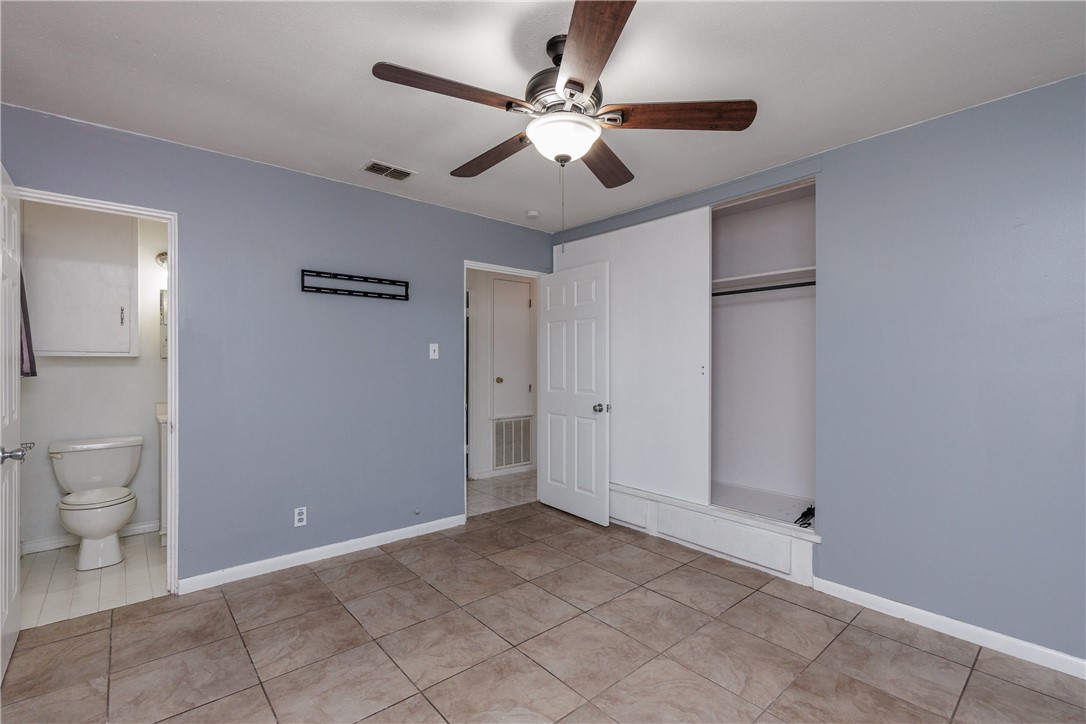 4122 Barnes Street Corpus Christi, TX 78411 - Photo 19 of 39 a view of a room with a ceiling fan and bathroom