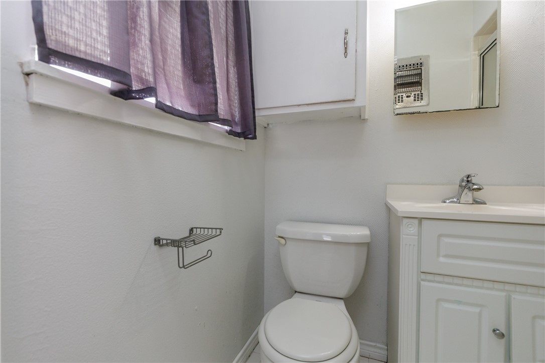 4122 Barnes Street Corpus Christi, TX 78411 - Photo 21 of 39 a bathroom with a toilet sink and mirror