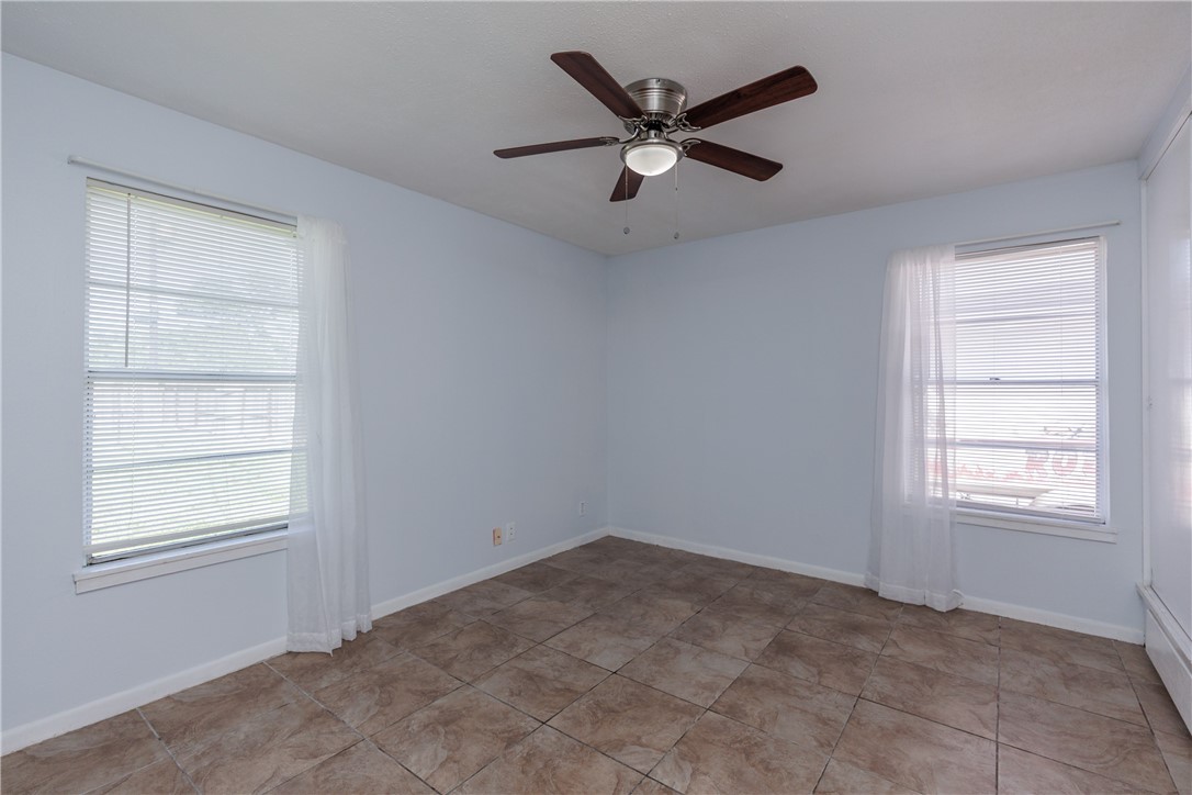4122 Barnes Street Corpus Christi, TX 78411 - Photo 22 of 39 an empty room with windows and fan