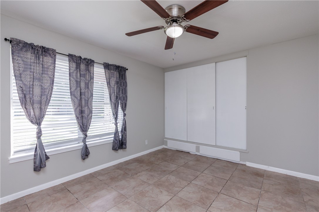 4122 Barnes Street Corpus Christi, TX 78411 - Photo 25 of 39 wooden floor in an empty room with a window