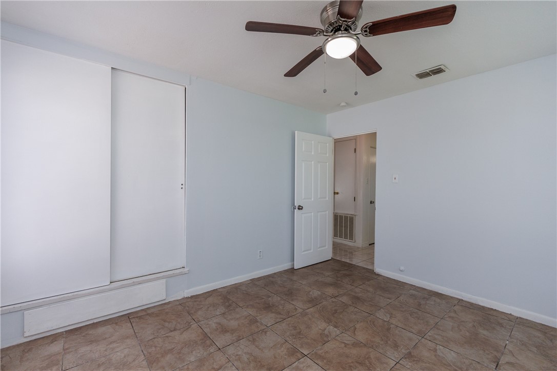 4122 Barnes Street Corpus Christi, TX 78411 - Photo 29 of 39 an empty room with closet and a chandelier fan
