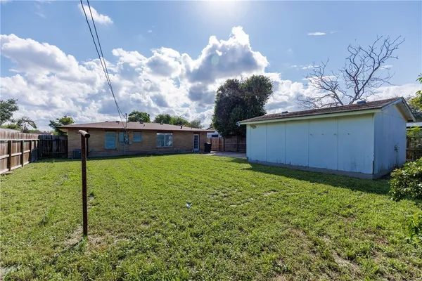 a view of house with backyard
