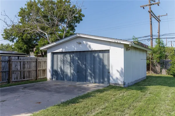 a backyard of house with wooden fence
