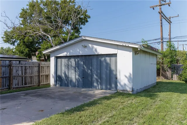 a backyard of house with wooden fence