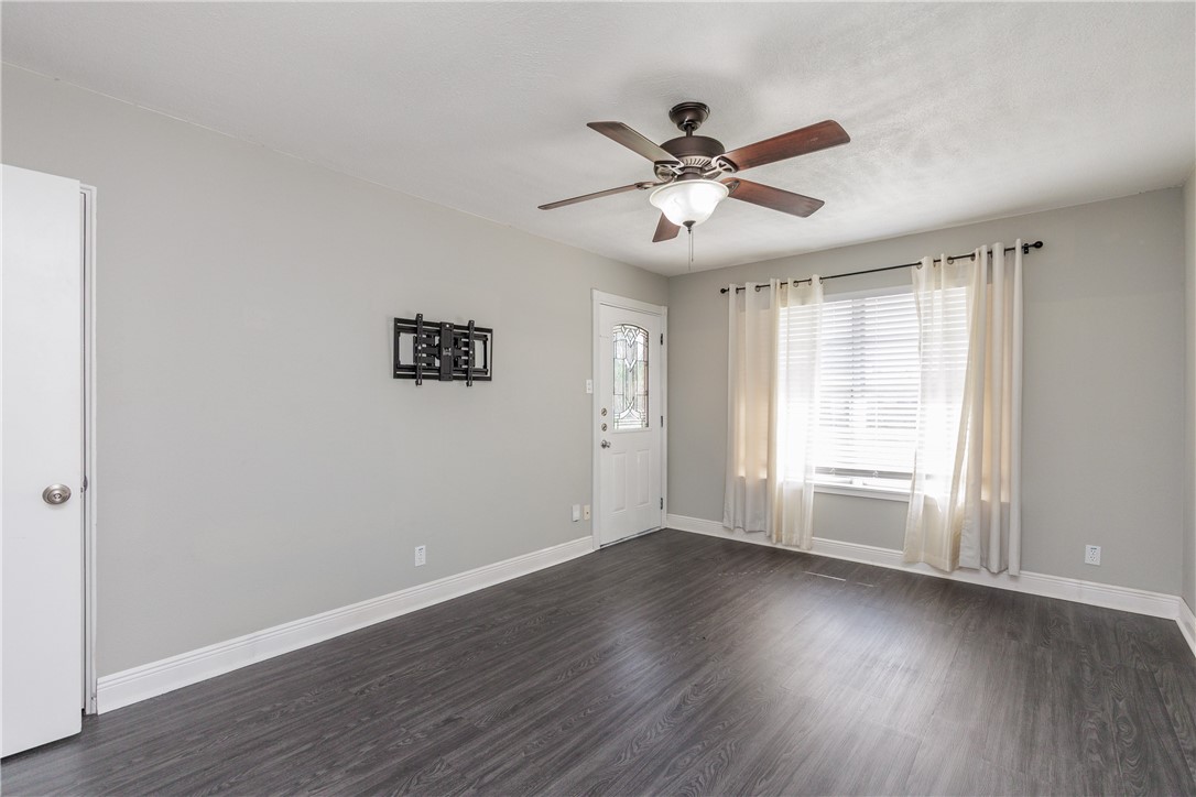 4122 Barnes Street Corpus Christi, TX 78411 - Photo 7 of 39 a view of an empty room with wooden floor and a window