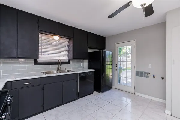 a kitchen with stainless steel appliances granite countertop a refrigerator and a sink