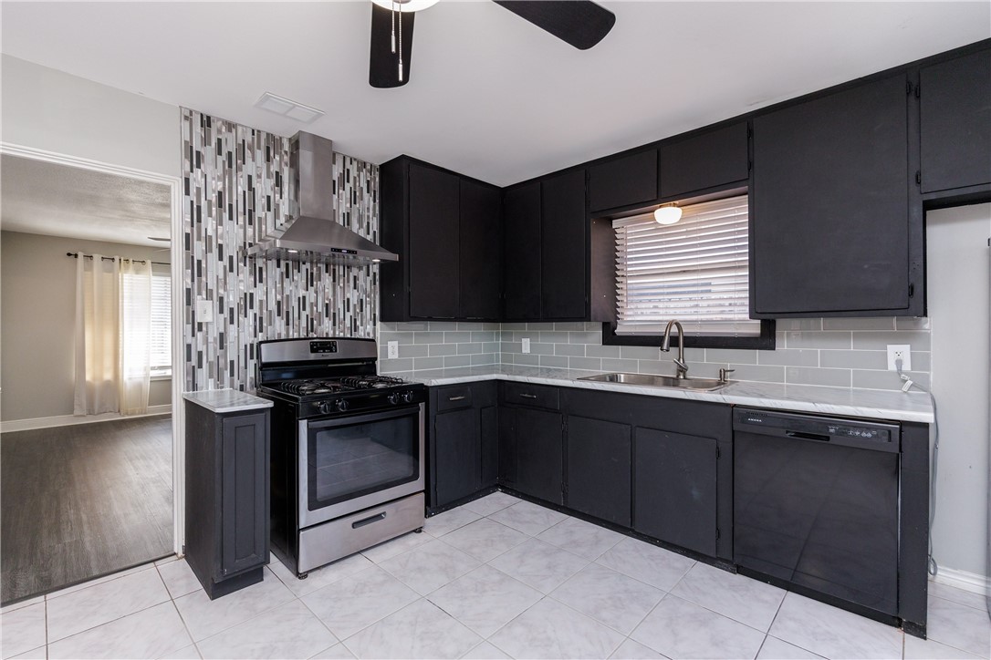 4122 Barnes Street Corpus Christi, TX 78411 - Photo 10 of 39 a kitchen with stainless steel appliances granite countertop a sink and a stove