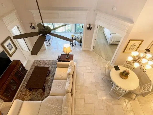 a living room with furniture and a floor to ceiling window
