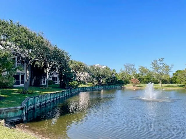 a view of a lake with houses in the back