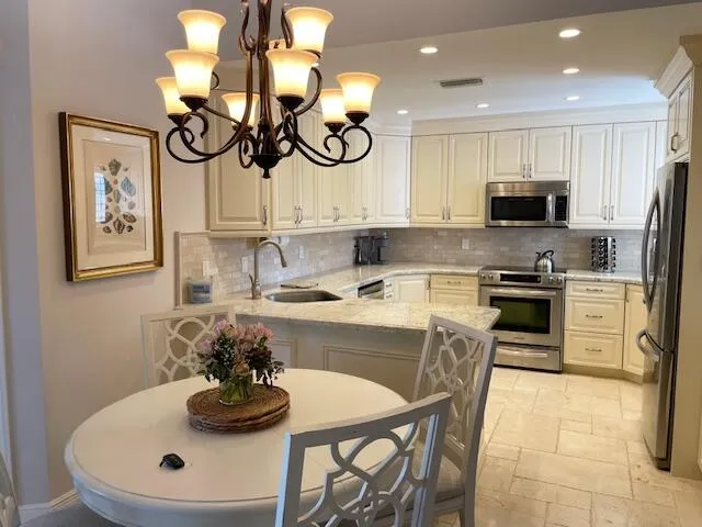 a kitchen with a table and chairs in it