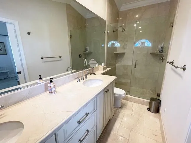 a bathroom with a double vanity sink mirror double and shower