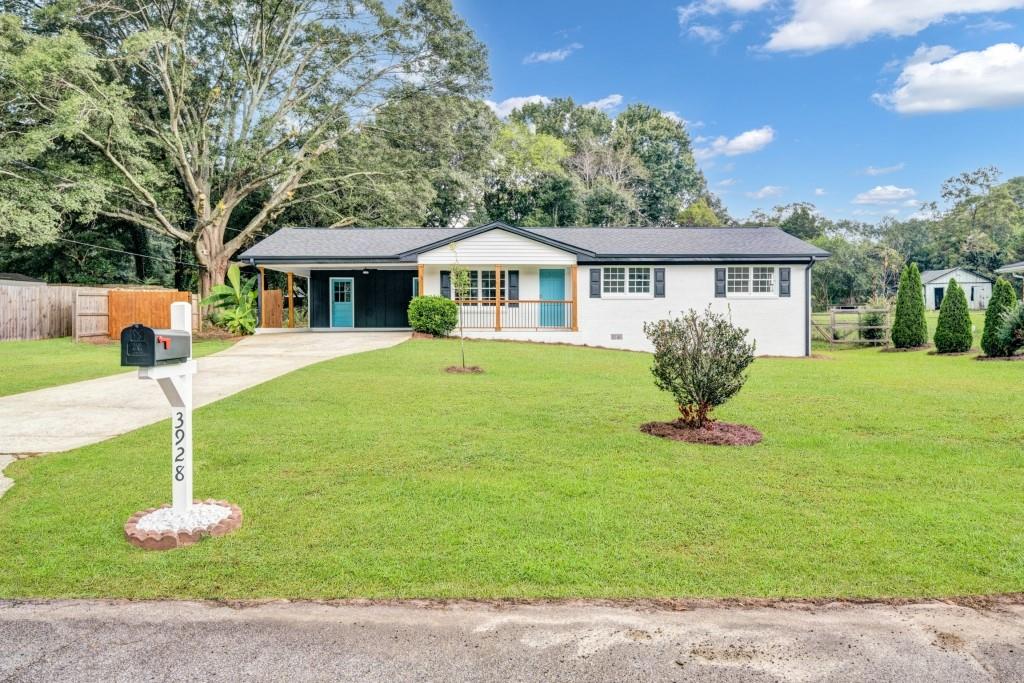 a front view of a house with a garden