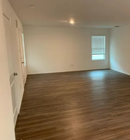 a view of a room with wooden floor and staircase